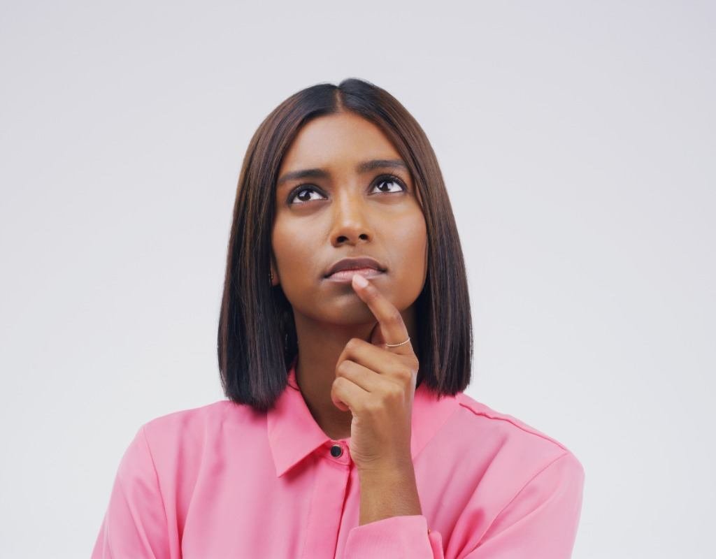 Woman-in-pink-shirt-thinking